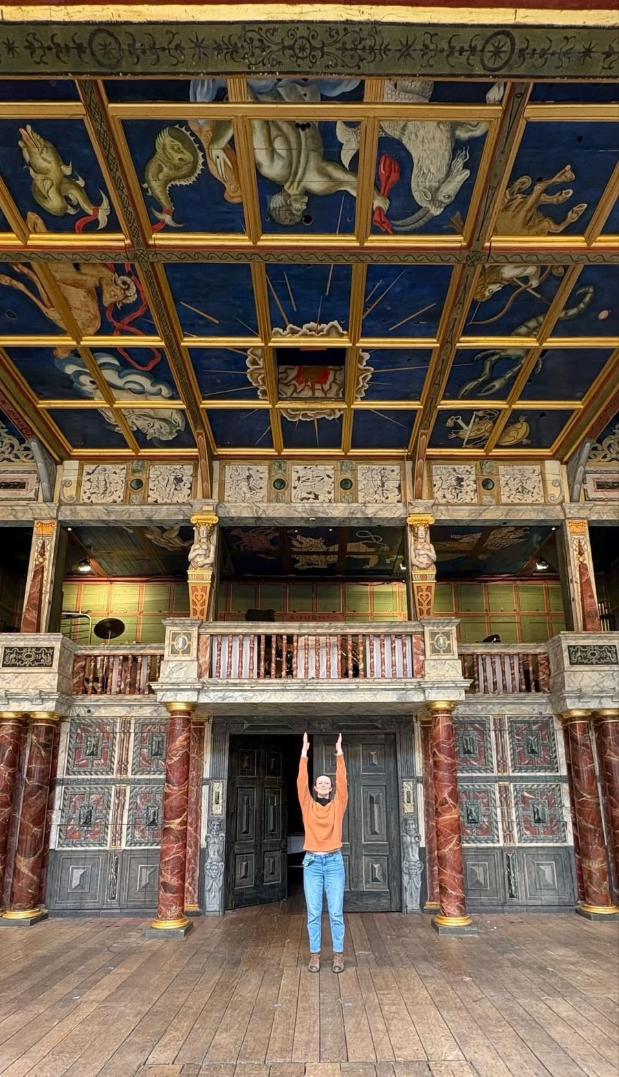 Nia Lynn on the stage of Shakespeare's Globe beneath the painted heavens